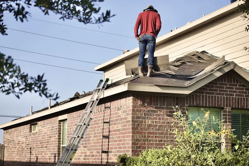 Professional roofer working on a residential roof in Fayette Acres